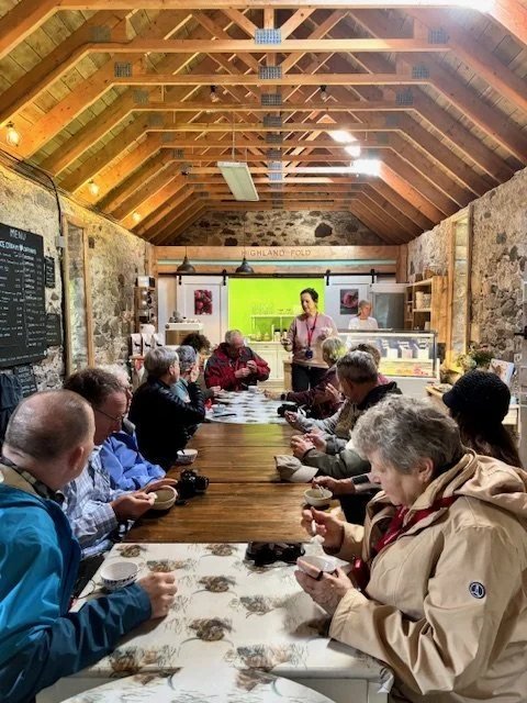 Guests around a long table in the farm barn at an ice cream tasting session